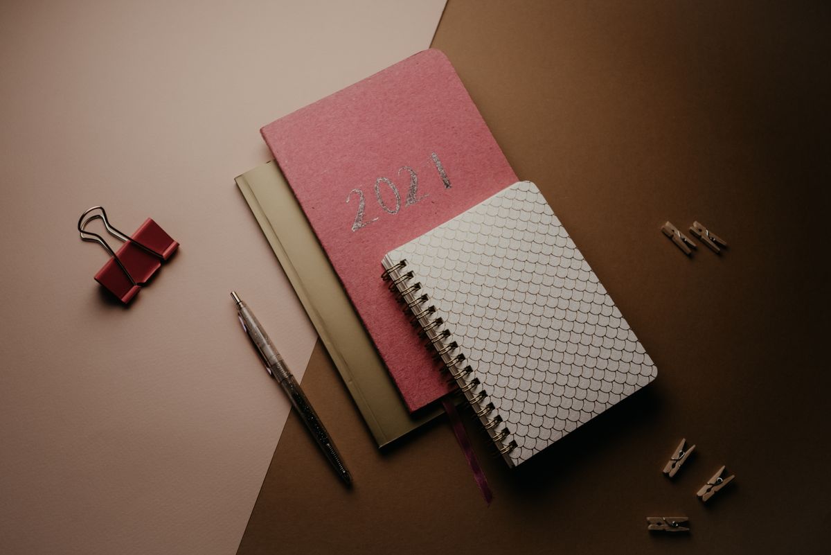 A plain notebook and pen on a wooden desk — the thirty-day comfort-and-wear log the review is built around
