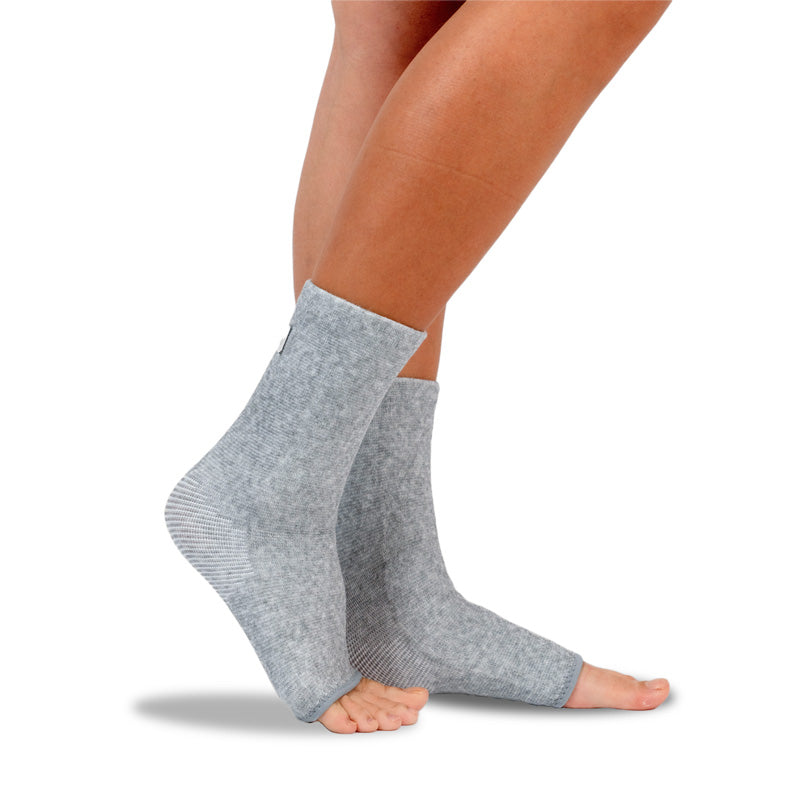 A pair of gray OneCompress Bamboo Footsleeves laid flat on a plain surface