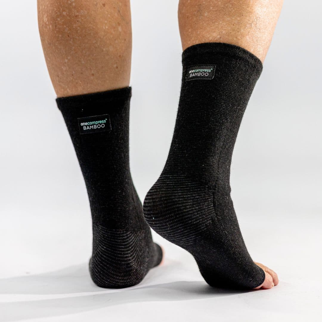 The OneCompress sleeve in black, shown from the side on a plain studio background